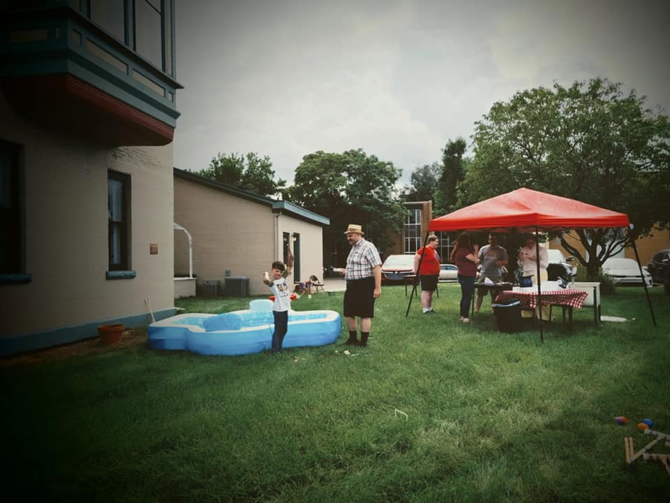 Gallery 1 - Image of last year's party, a child cheers after catching a toy fish in the inflatable fishing hole