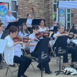 Gallery 1 - A picture of Simply Strings performing outdoors at Rackham Park. 